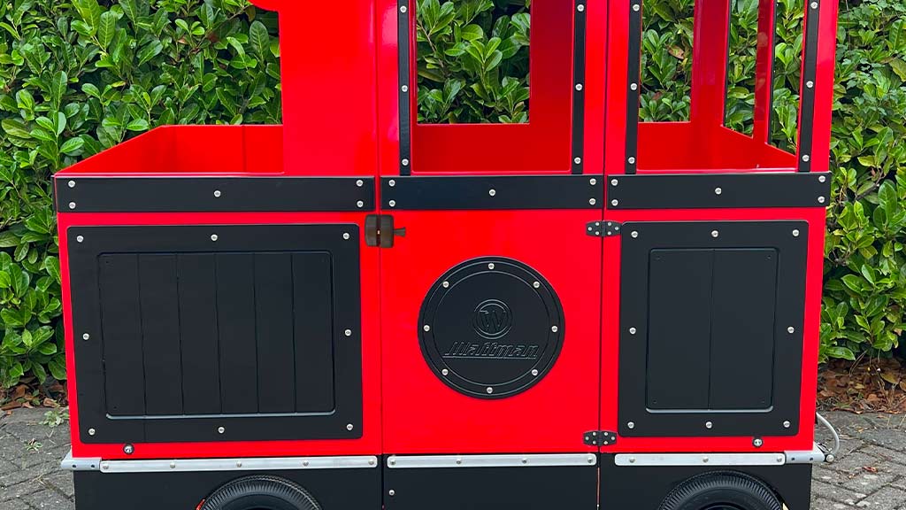 Wattman passenger wagon displaying custom advertising panels with sponsor branding and promotional messages